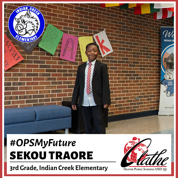 Sekou stands in school lobby